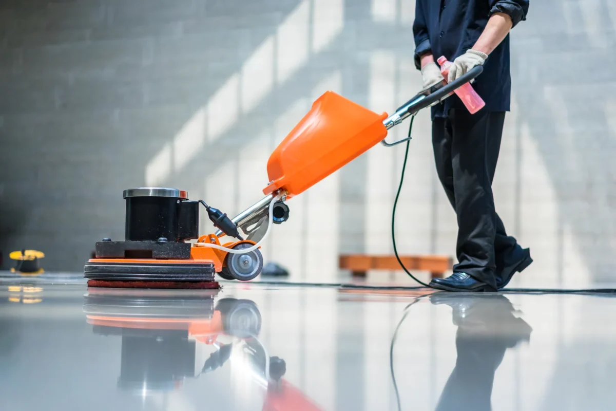 Rotary cleaning machine in use on a polished hard floor