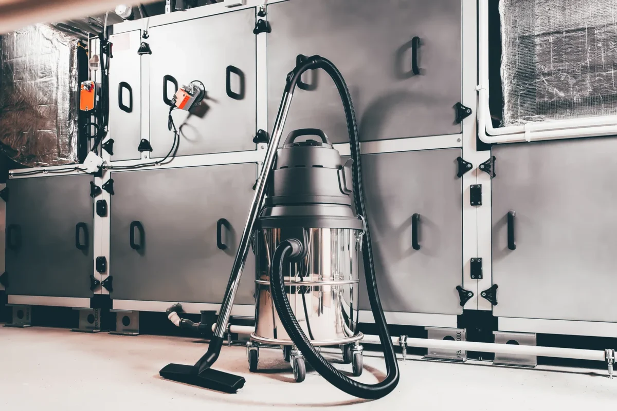 Industrial vacuum cleaner beside factory ventilation equipment